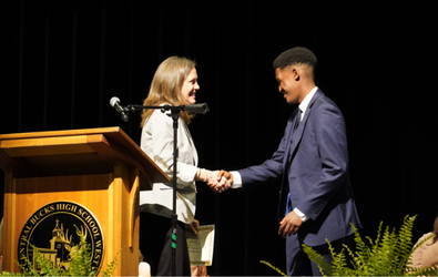  CB West student reciveing scholarship on stage